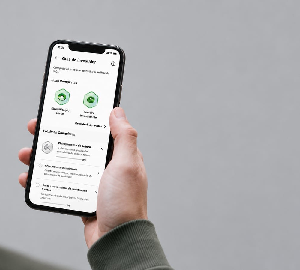 The Investor Guide open on a phone, held in the hand