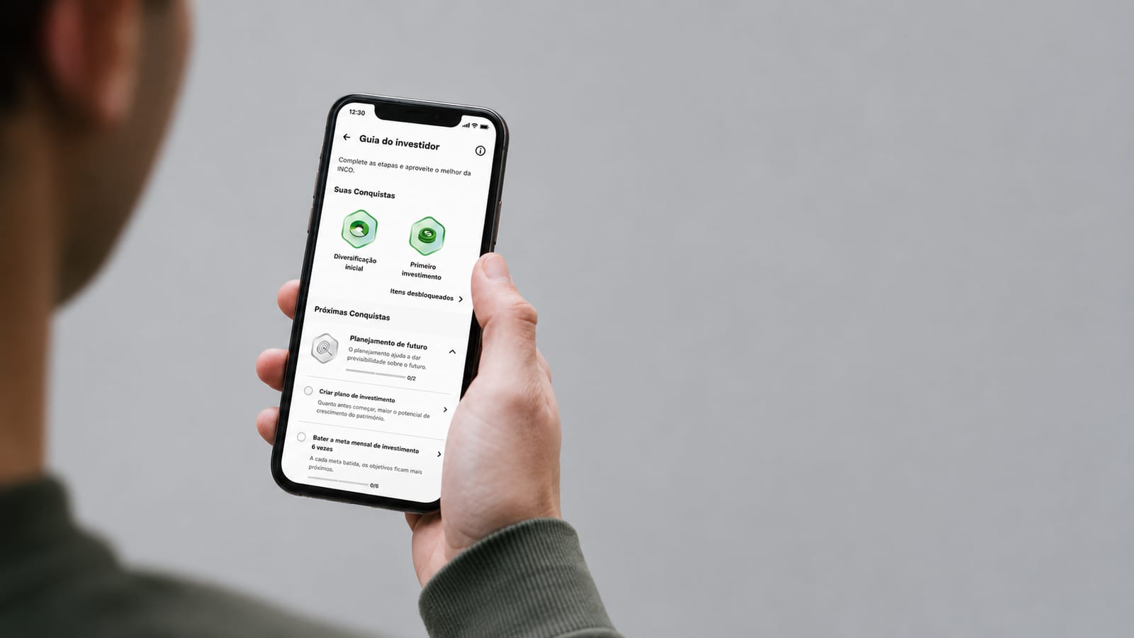 The Investor Guide open on a phone, held in the hand